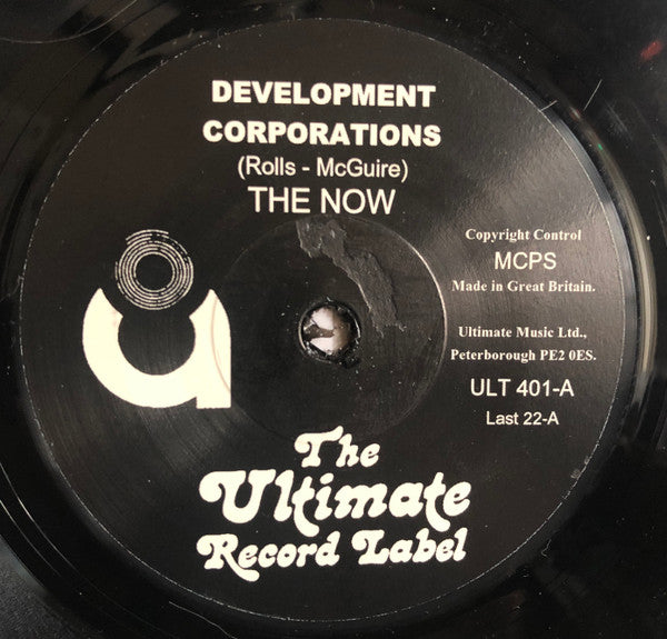 The Now (4) : Development Corporations (7", Single, RE)